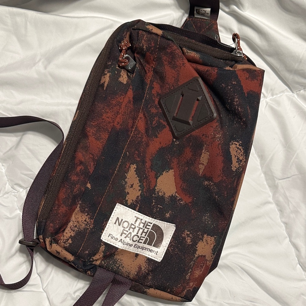 The North Face Rust and Black Camo Sling Backpack